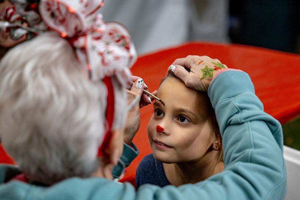 A child gets her face painted at Christmas on the Quad. Photo by Sarah Conroy.