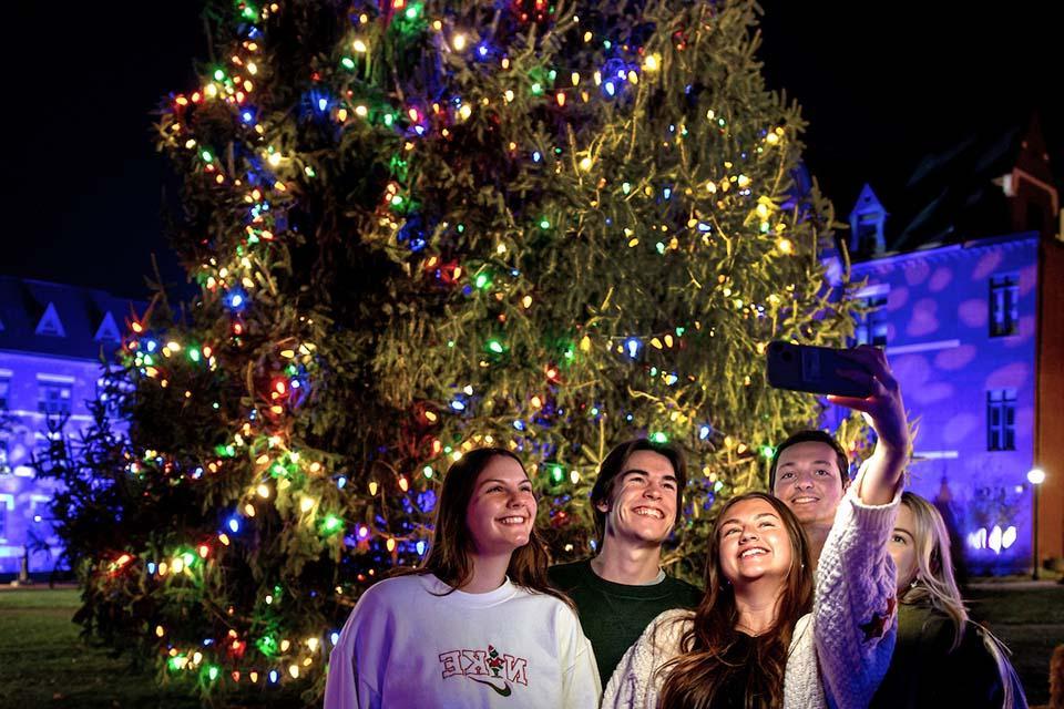 A group of attendees pose for a selfie at Christmas on the Quad. Photo by Sarah Conroy.